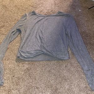 Grey silk top, long sleeved and it twists in the front.